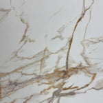 Close-up of a marble Top surface with beige and brown veins.