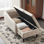 White upholstered storage ottoman with open lid revealing cushions on a patterned rug.