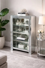 Silver mirrored crushed cabinet with shelfs in a living room setting with decor items.