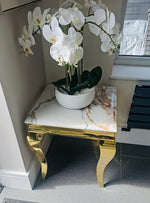 The Gold-White Lewis Lamp Table combines refined Italian design with practical functionality. Featuring four sleek contemporary legs and a polished chrome frame, this piece delivers understated elegance to any interior. A versatile accent table that bridges modern minimalism with timeless sophistication.
Dimension: 50 x 50 x 55 cm