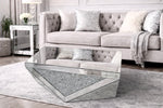 Modern living room with a mirrored coffee table and gray sofa.