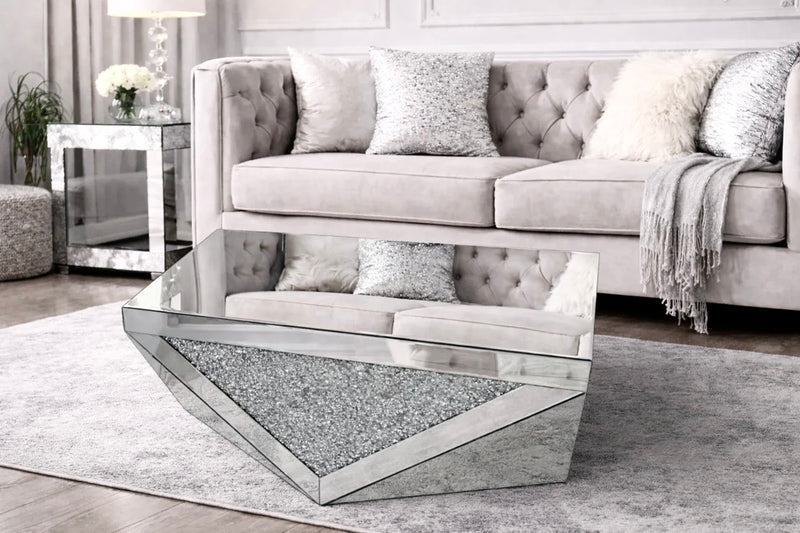 Modern living room with a mirrored coffee table and gray sofa.
