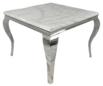 The Lewis 1m Square Dining Table combines refined Italian design with practical elegance. Its marble top provides a sophisticated, durable surface that resists staining and heat, whilst the polished chrome frame delivers a contemporary aesthetic with exceptional structural integrity. Four tapered legs in the Italian style create visual lightness whilst maintaining stability. Ideal for modern dining spaces, this compact square format accommodates intimate gatherings without compromising on style or quality c
