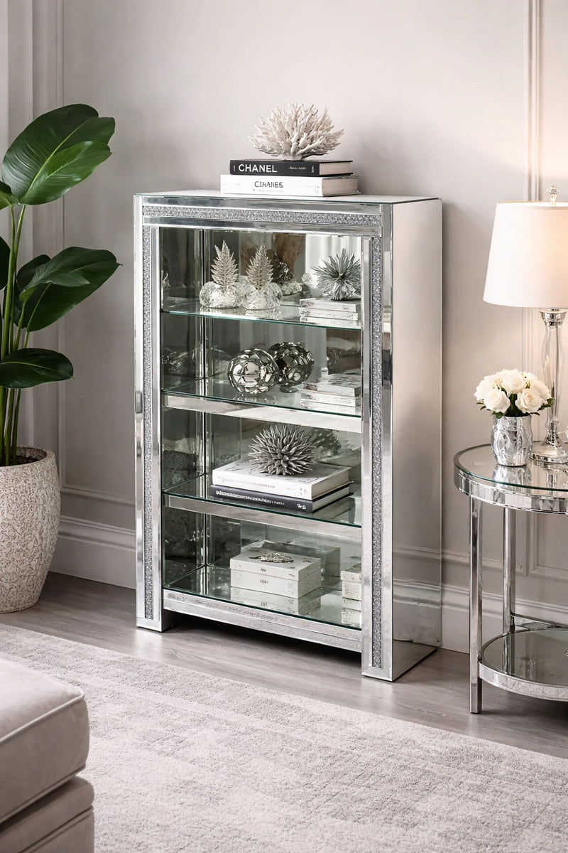 Silver mirrored crushed cabinet with shelfs in a living room setting with decor items.