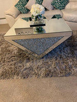 Add a touch of glamour and elegance to your living room with the Roma Crushed Diamond Coffee Table. With its luxurious mirrored finish and stunning crushed diamond inlay on Each Side Giving It A Detailed Finish &amp; Comes With A Mirrored Top &nbsp;while the mirrored surfaces make your room feel brighter and more expansive.
