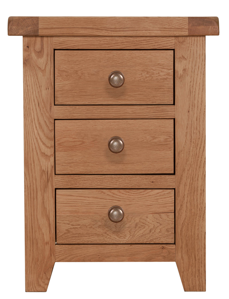 Solid oak wood bedside table with three drawers featuring brass-style knobs and tapered legs.